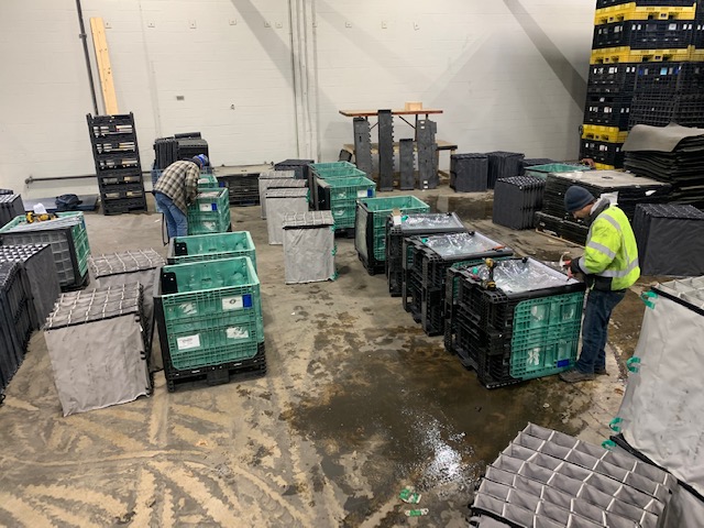 Michigan Industrial Container employees perform bulk plastic container repairs on containers with dunnage.