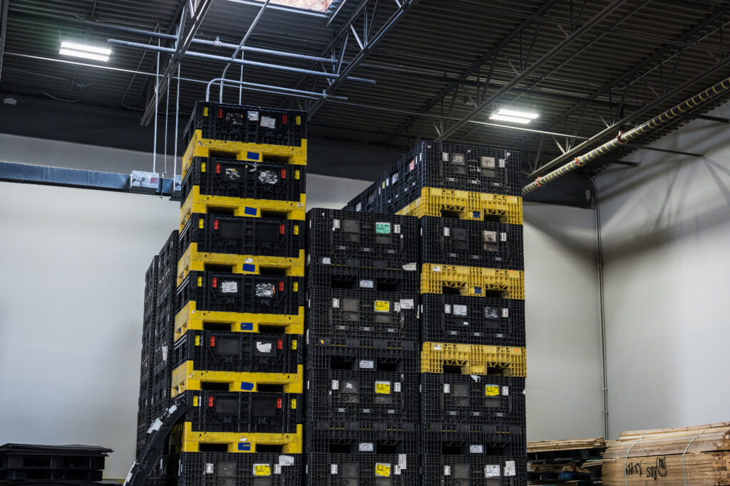 Stacks of plastic shipping containers, ready for purchase or lease