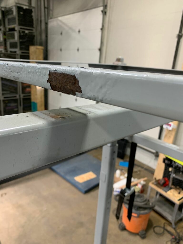 The "Before" state of a steel rack awaiting repair
